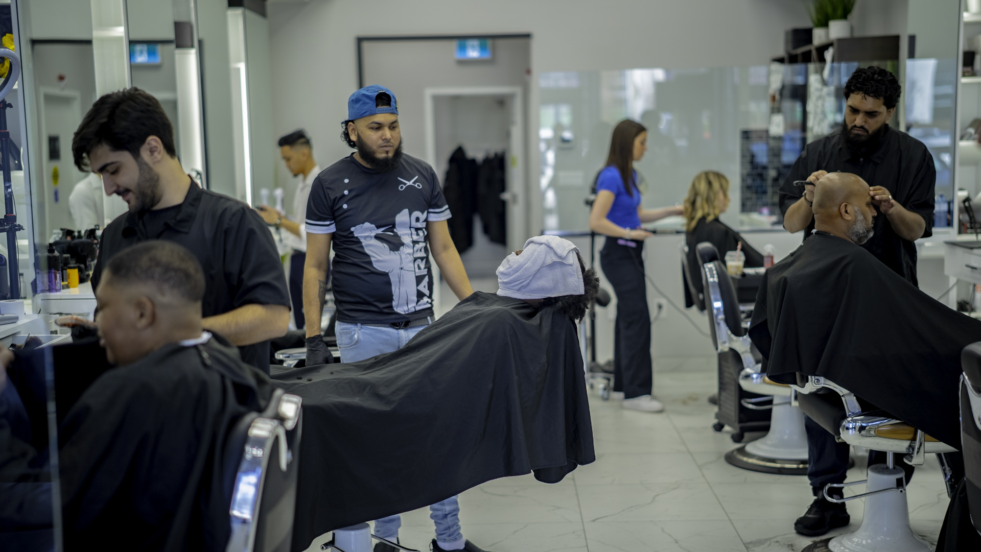 Modern barbershop interior with styling chairs and rustic wooden decor
